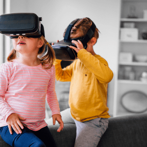 Two small children playing with a virtual reality set